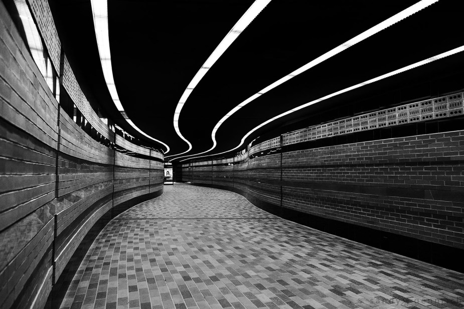 Architectural Arcs.  ISO 3200. 24mm. 1/50th @ f4.  Processed with Nik Silver Effects, Luminosity Masks, and Photoshop.   